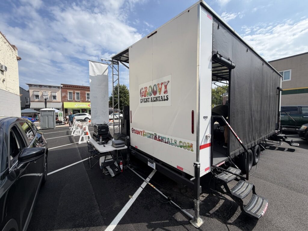 Groovy Event Rentals stage trailer with truss and stairs, seen from the side